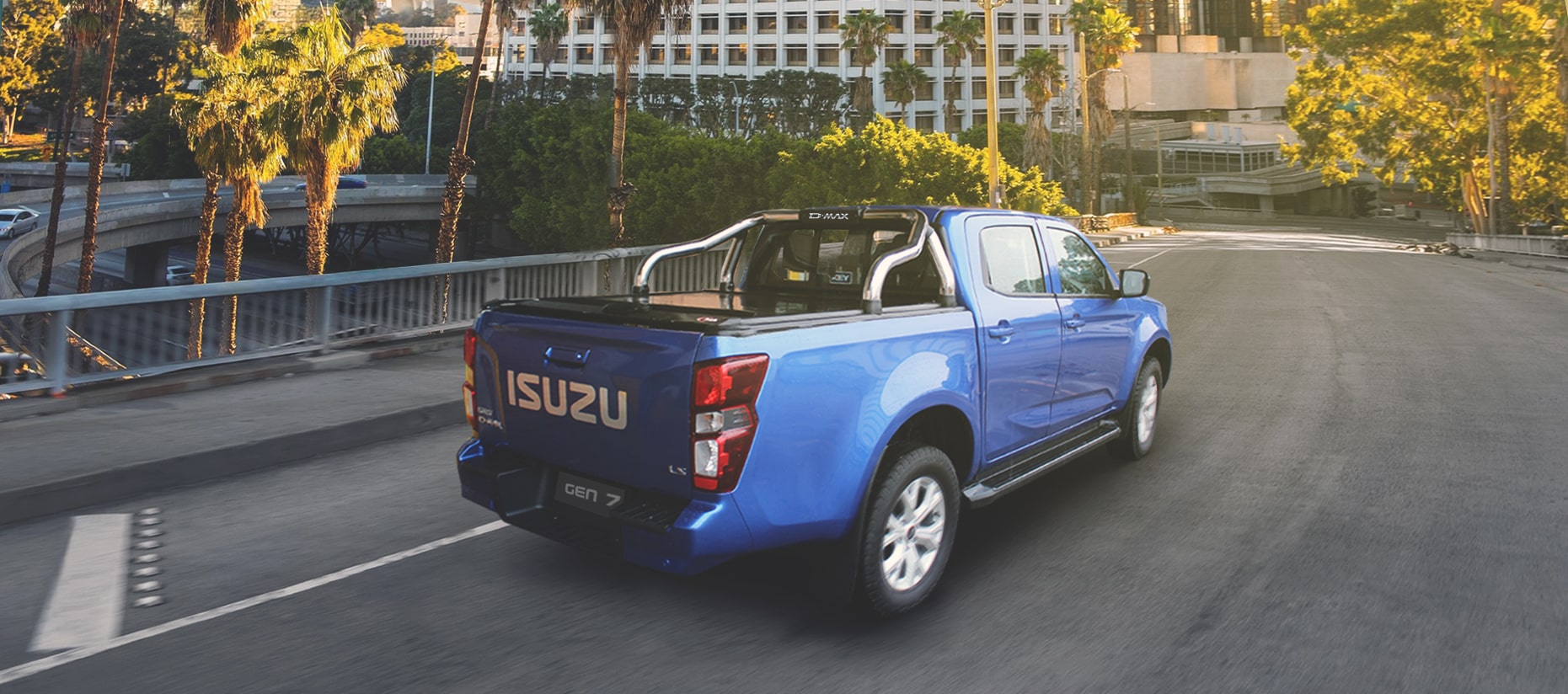 Isuzu D Max with MAXE RollaTop roller shutter driving on the road, showcasing the D Max load bin cover.